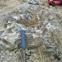 Photo of the poorly-exposed B-2 breccia pipe with quartz-tourmaline and abundant limonites. Initial sampling returned values to 0.18 g/t Au and 10.9 g/t Ag over a 2m width