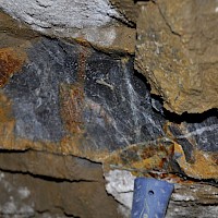 Oxidized wallrock from 200 Level Adit.  Note potasic alteration and stockworks of quartz magnetite and copper